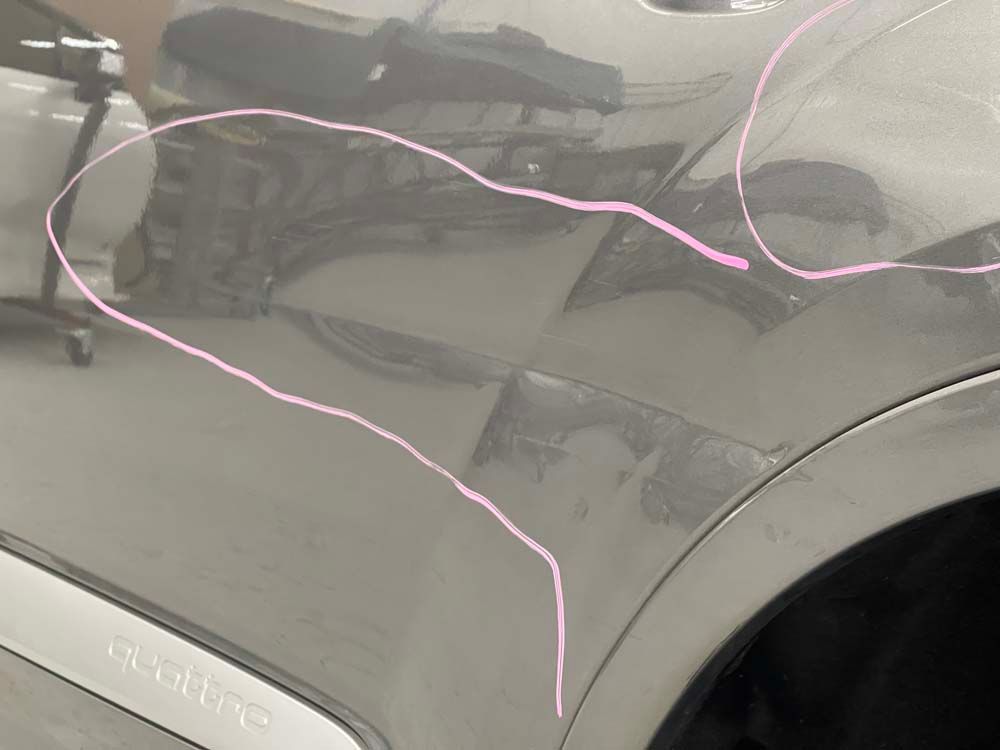 A close up of a car with a pink line drawn on it
