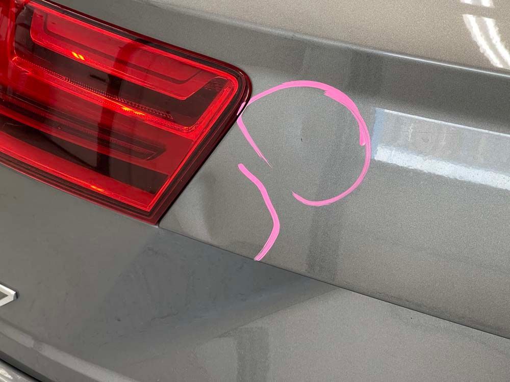 A close up of the back of a car with a pink circle drawn on it.