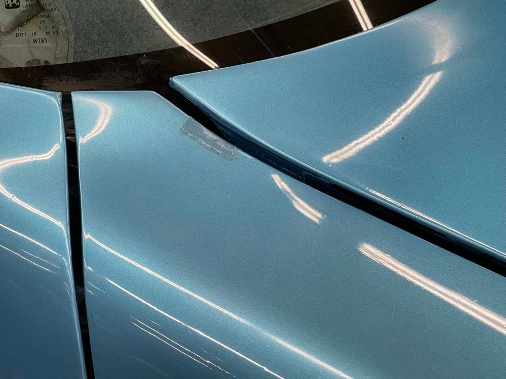 A close up of the side of a blue car