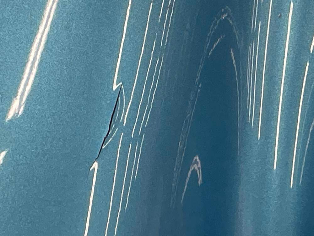 A close up of a blue wall with white lines on it