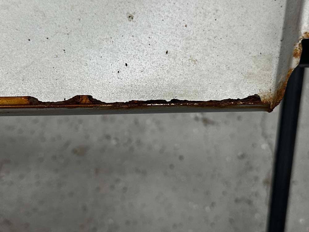 A close up of a piece of metal with rust on it.
