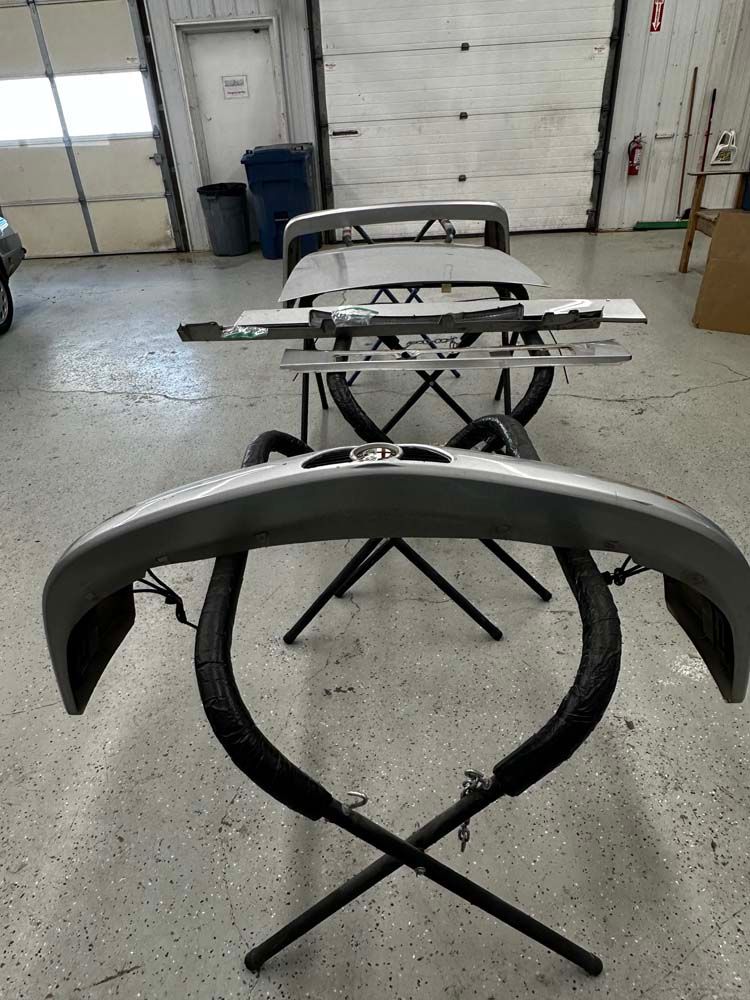 A bumper is sitting on a stand in a garage.