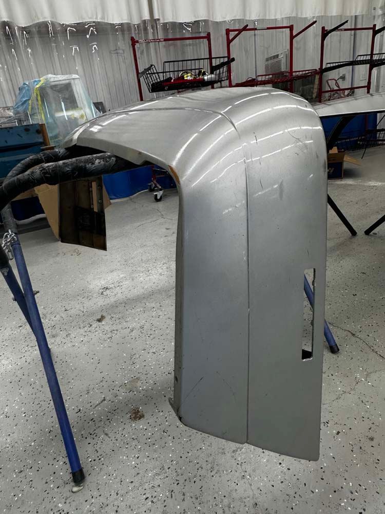 A piece of metal is sitting on a table in a garage.