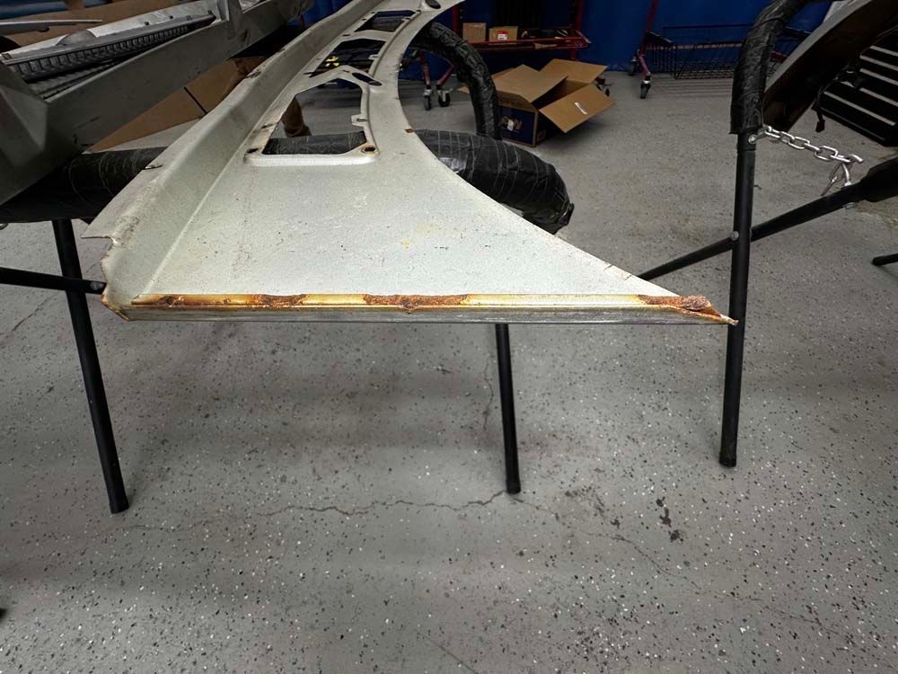 A piece of metal is sitting on a table in a garage.