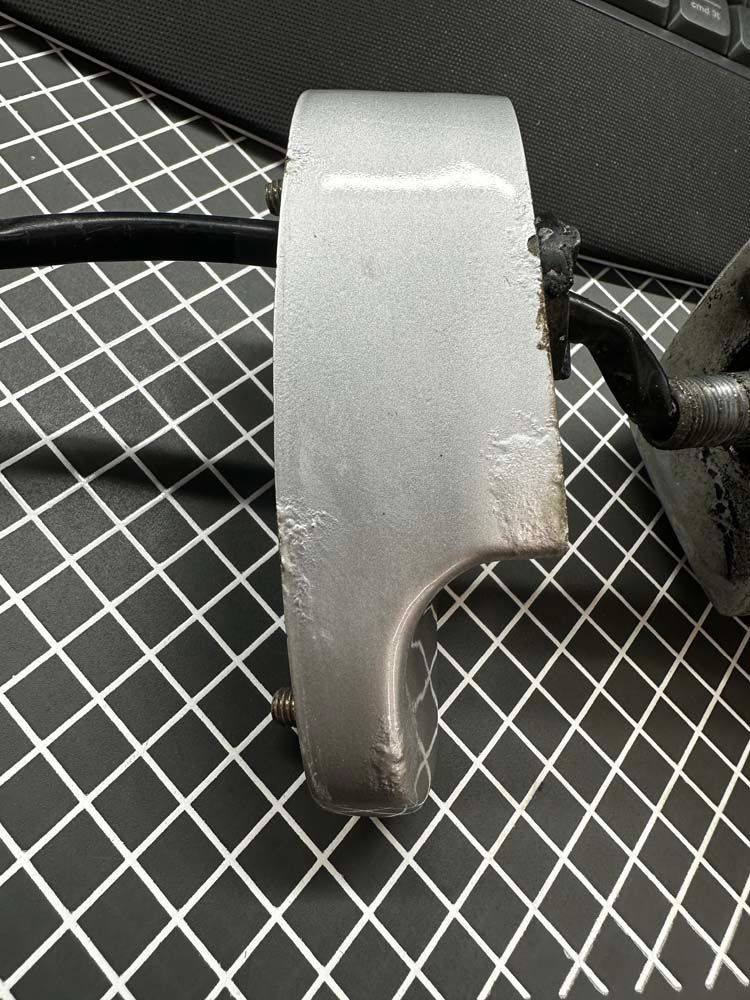 A silver object is sitting on a black and white checkered table next to a keyboard.