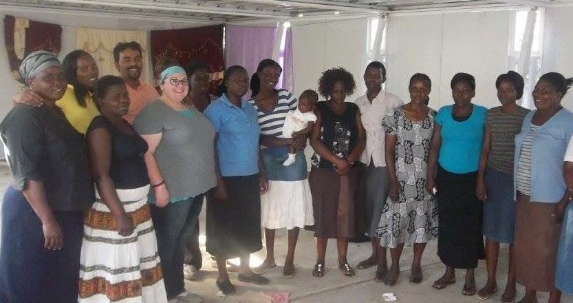 A group of people are posing for a picture in a room.