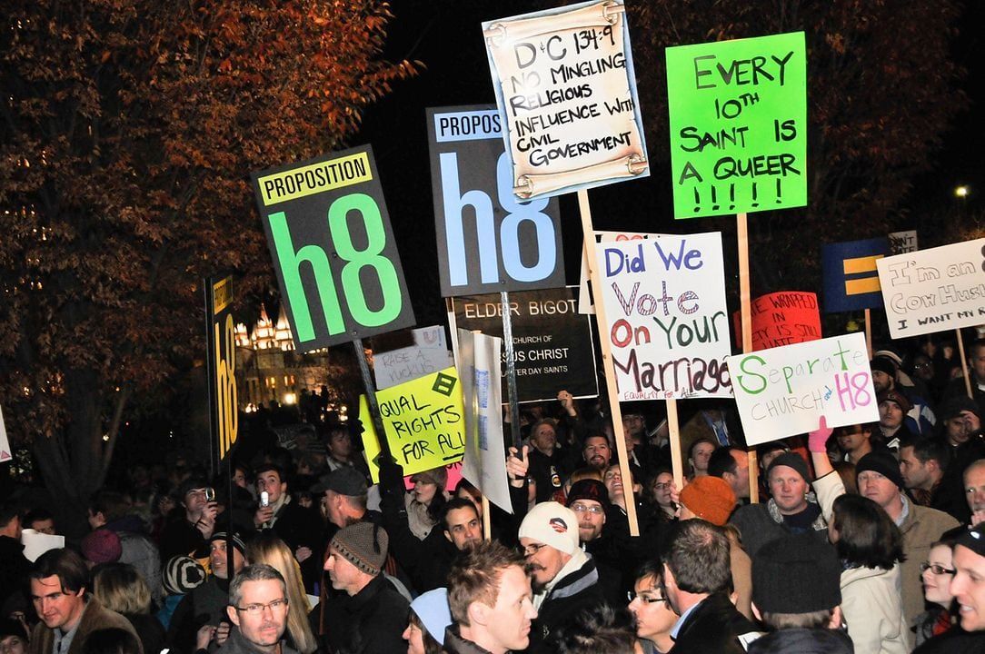 Protest with signs, some reading