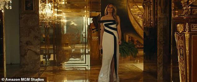 Melania Trump in white dress on stage at a nightclub