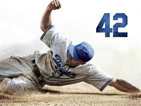 Baseball player Jackie Robinson sliding into home plate, wearing a Dodgers uniform, with