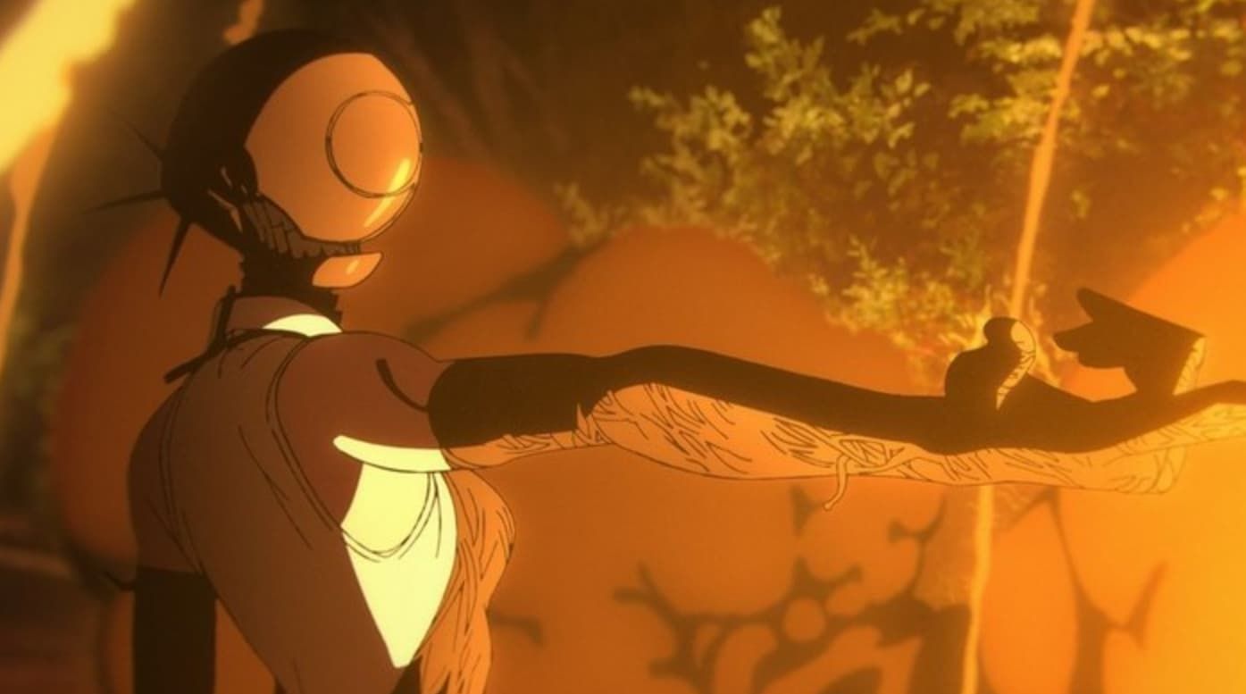 Michael Douglas in a convertible car, wearing sunglasses and a suit, looking to the side.