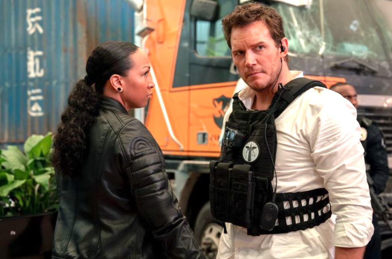 Man smiles in car, with Alvin and Simon chipmunk dolls in the front seat.