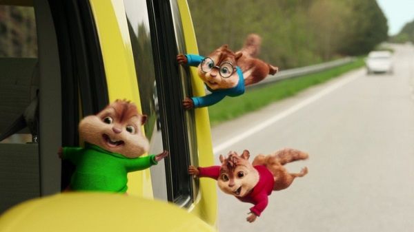 Three cartoon chipmunks hanging out of a yellow van window on a highway. They have different colored shirts and look happy, with wind blowing through their fur.