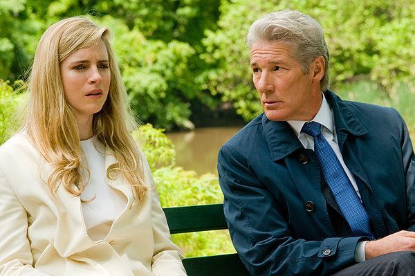Woman and Richard Gere on a park bench; she looks concerned, he gazes to the side.