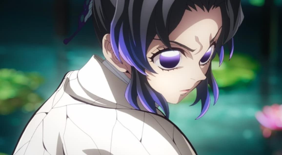 Man in suit walking on city street, cars and taxis in background.