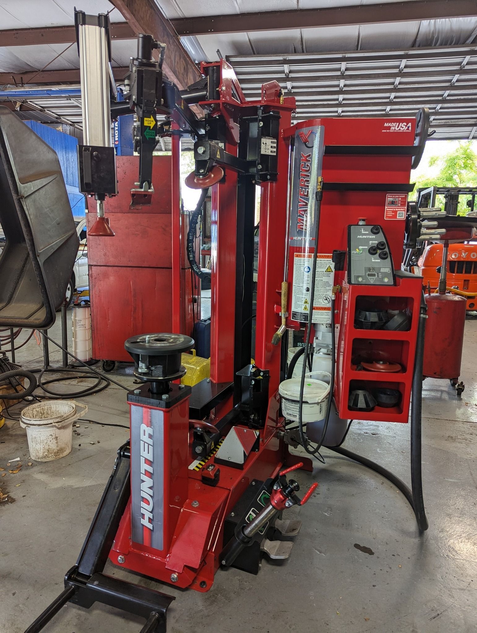 A red Hunter tire changer machine in a garage | Dunedin Garage