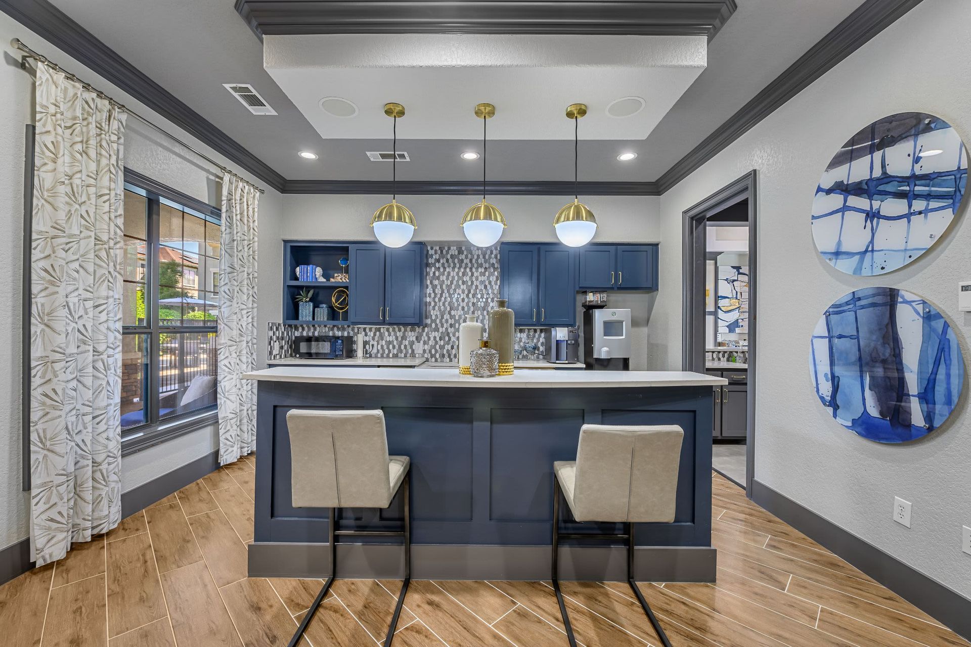 A kitchen with a large island and two chairs at Marquis Lakeline Station in Austin, TX.
