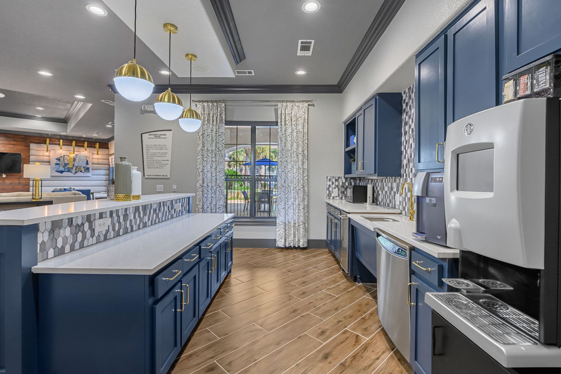 A kitchen with blue cabinets and stainless steel appliances at Marquis Lakeline Station in Austin, TX.