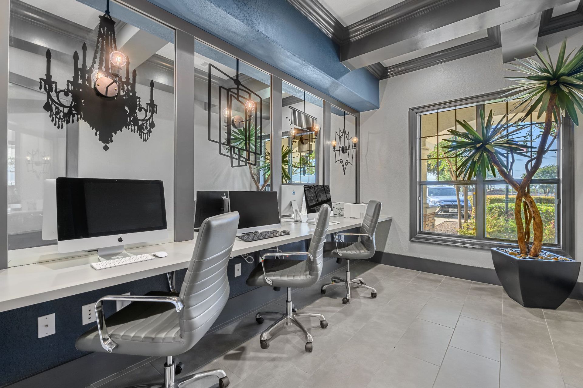A row of desks with computers and chairs in an office at Marquis Lakeline Station in Austin, TX.