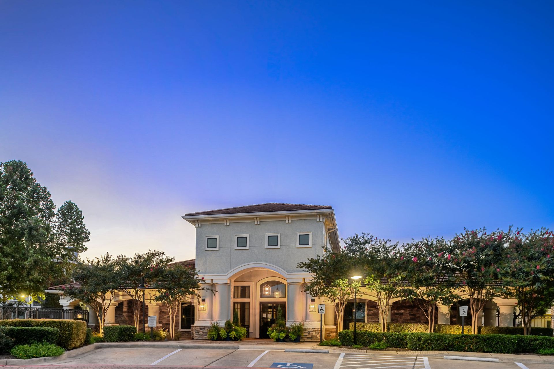 A large building with a parking lot in front of it at Marquis Lakeline Station in Austin, TX.
