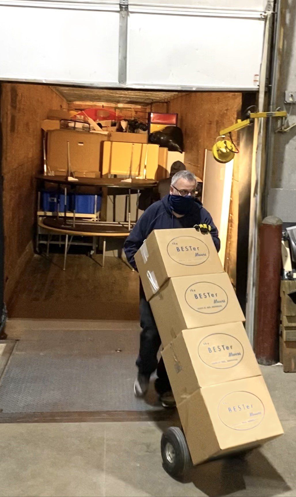 A Man Moving The Boxes From Storage Room — Minneapolis, MN — Bester Bros Transfer & Storage Co