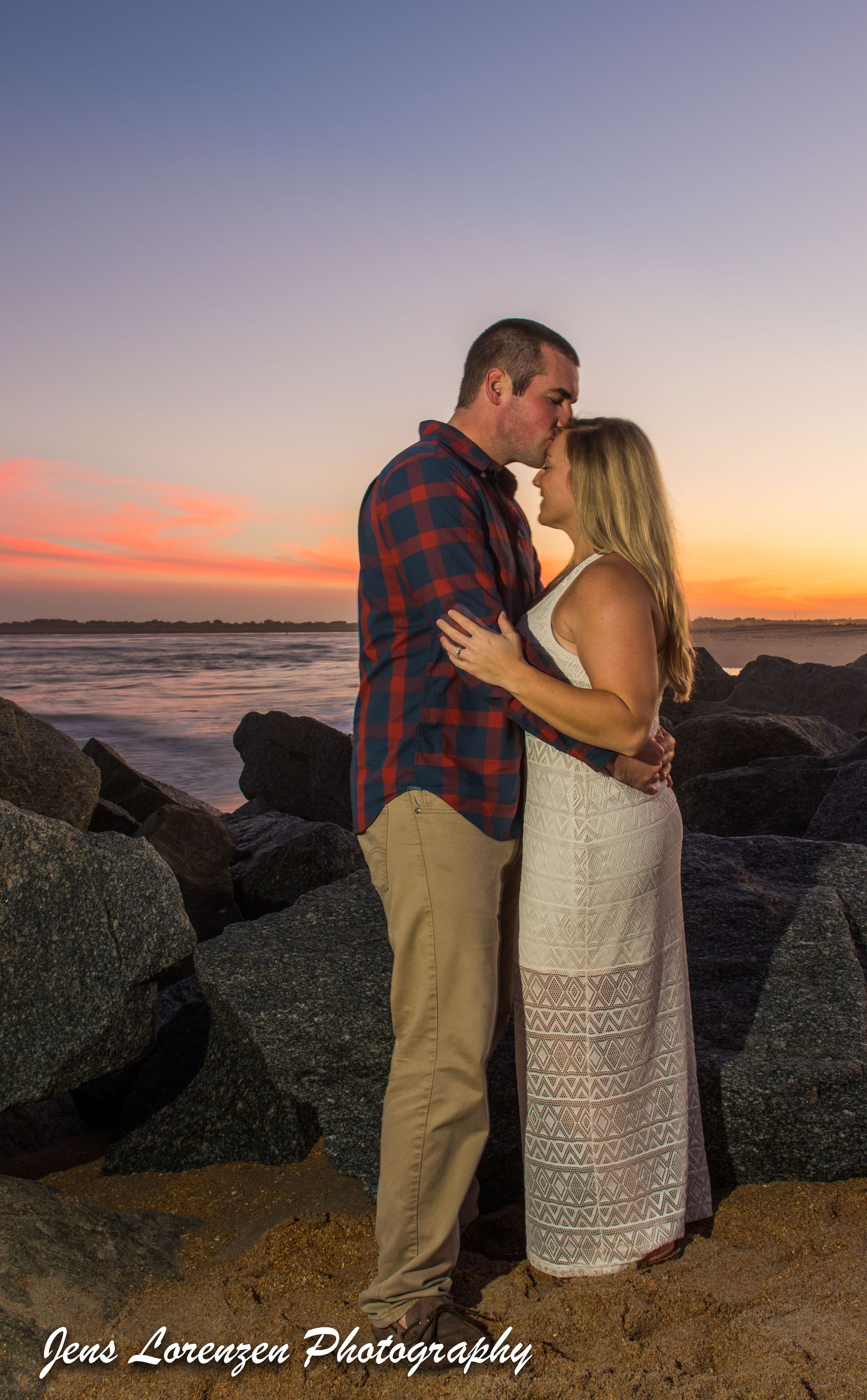 Man Kissing His Fiance on Forehead
