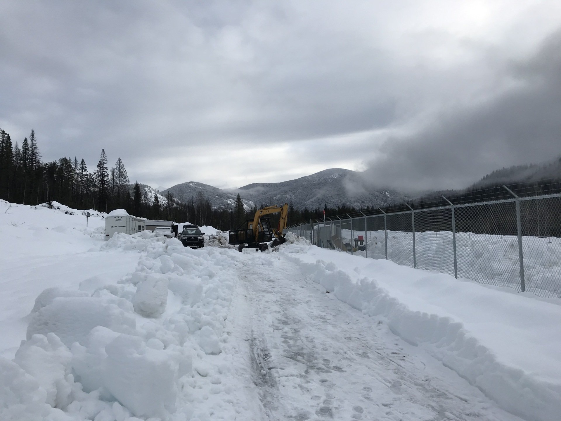 Installing security at an outdoor cannabis grow in British Columbia during the winter