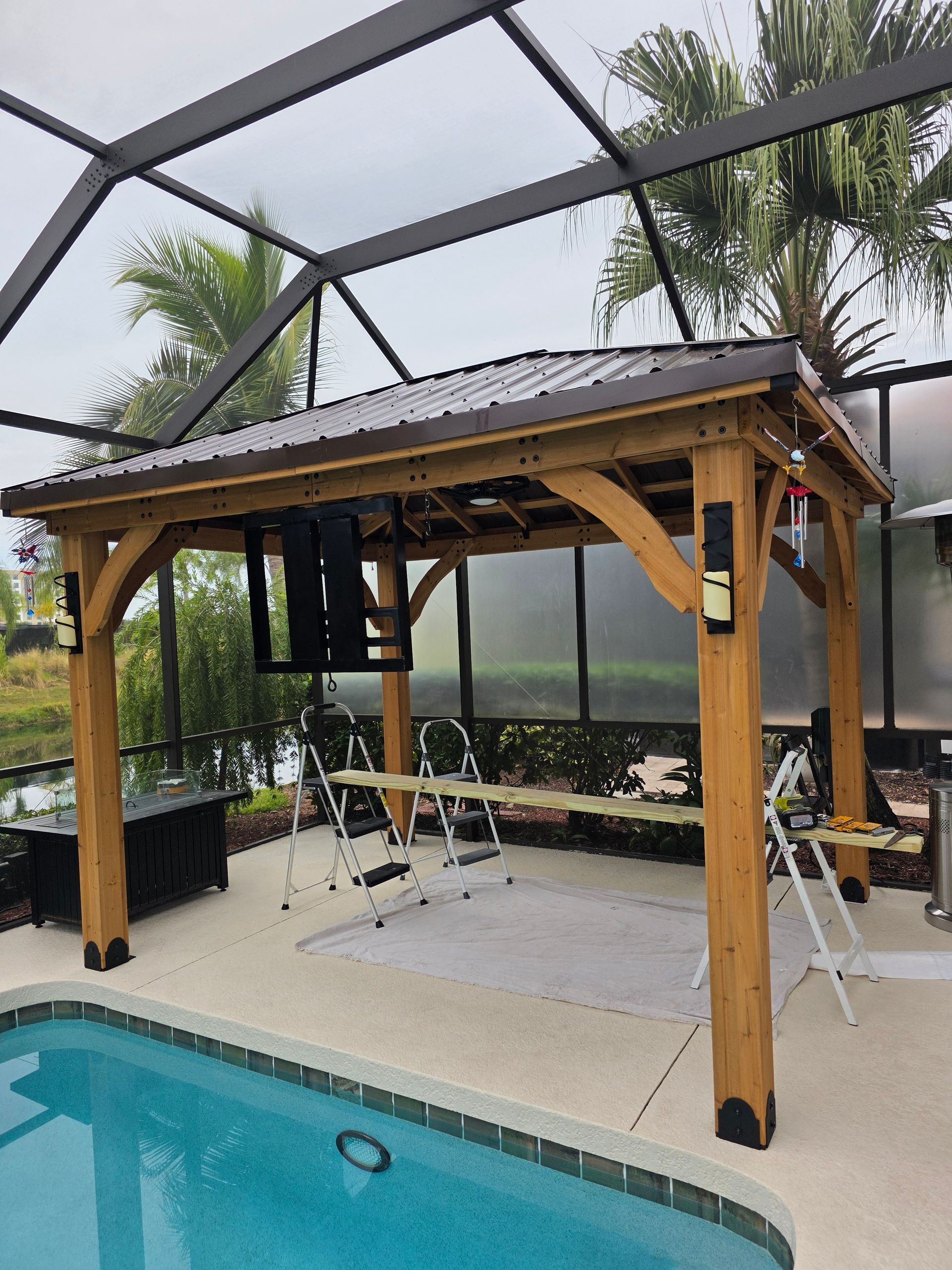 Two people install wall tiles with leveling systems, indoors.