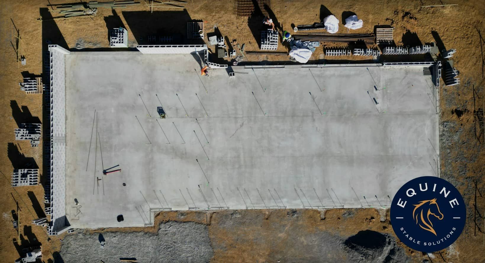An Aerial View Of A Large Concrete Building Under Construction — Equine Stable Solutions In Diddillibah, QLD