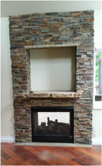 A fireplace with a stone wall and a wooden floor