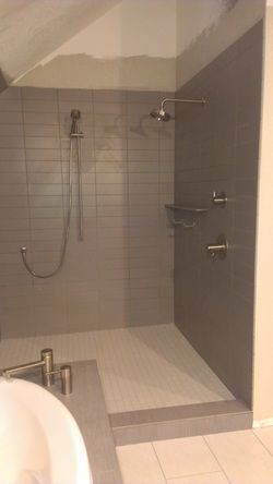 A bathroom with a walk in shower and a bathtub.