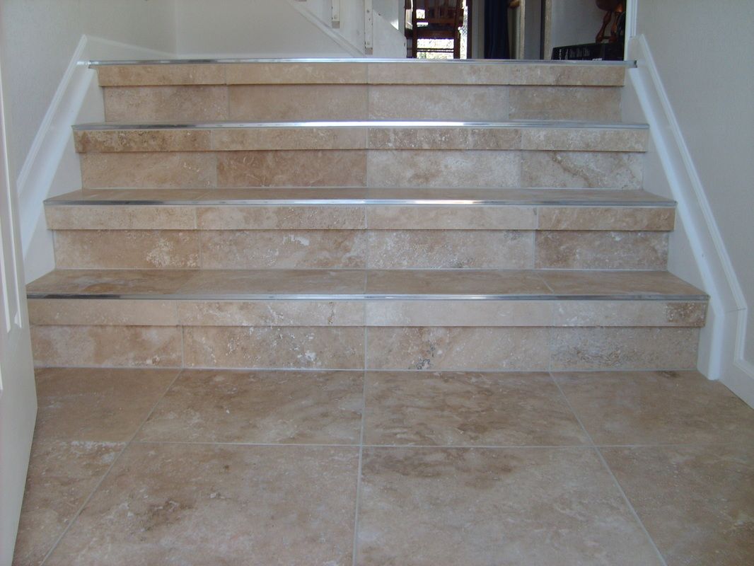 A set of marble stairs with a white railing
