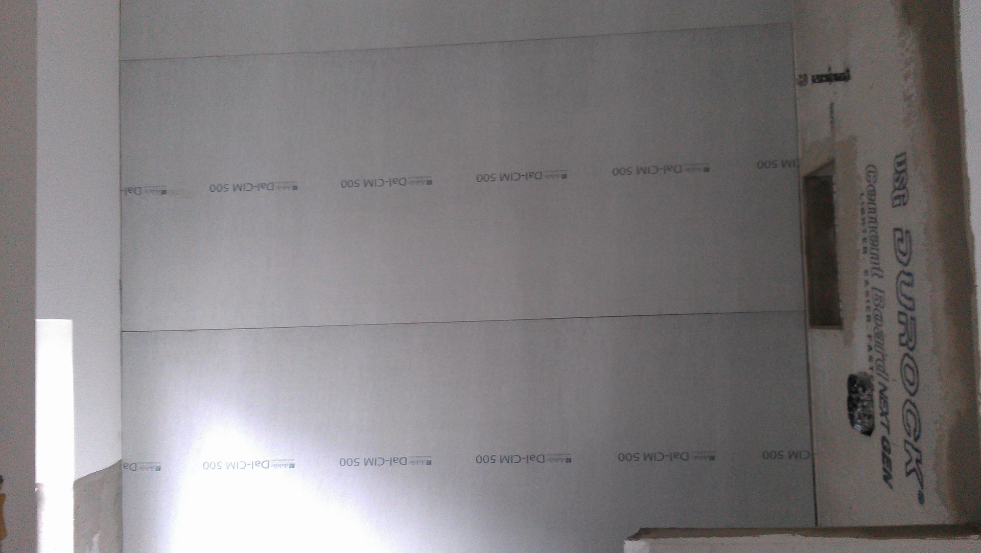 A room with a lot of white walls and a ceiling.