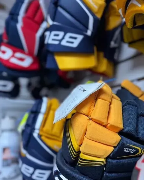 A close up of a pair of bauer hockey gloves