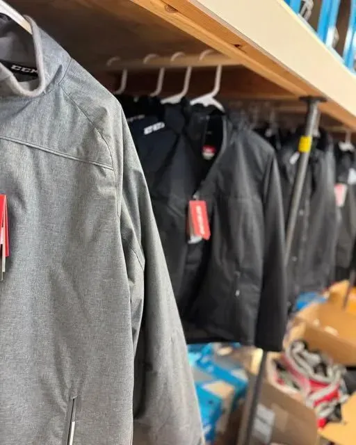 A row of columbia jackets hanging on a rack