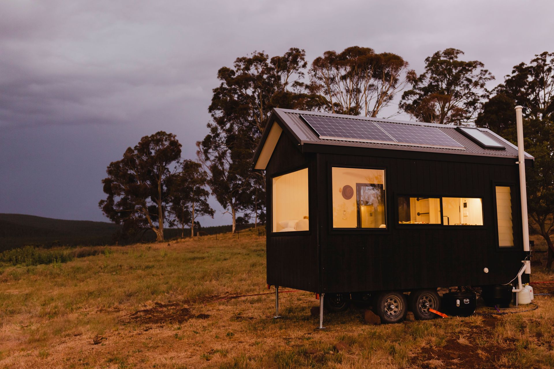 Tiny Black Cabin on Wheels With Solar Panels — ASAP Towing Pty Ltd In Tin Can Bay, QLD
