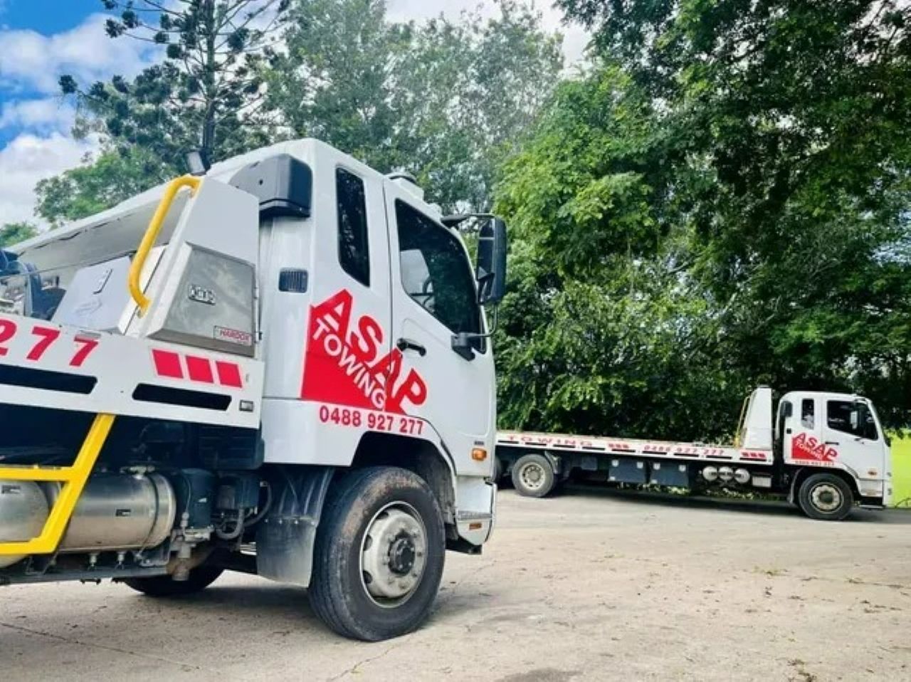 Two White Tow Trucks Parked Outdoors — ASAP Towing Pty Ltd In Gympie, QLD