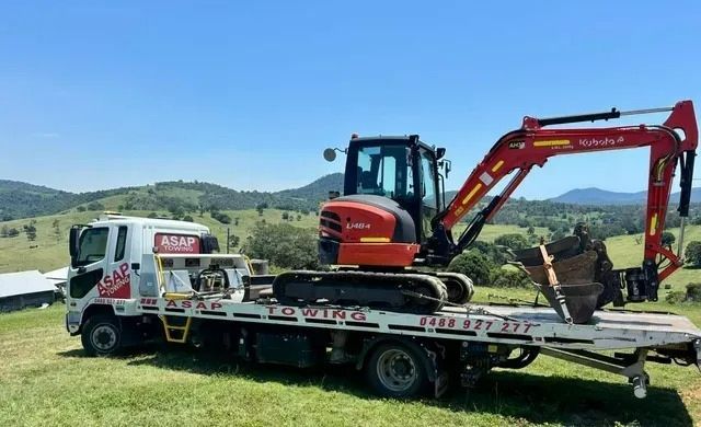 Red Excavator on a Tow Truck — ASAP Towing Pty Ltd In Tin Can Bay, QLD