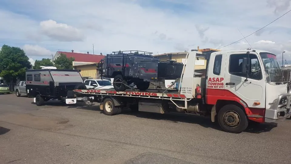 A Tow Truck Hauling a Trailer With an Off-road Camper — ASAP Towing Pty Ltd In Gympie, QLD