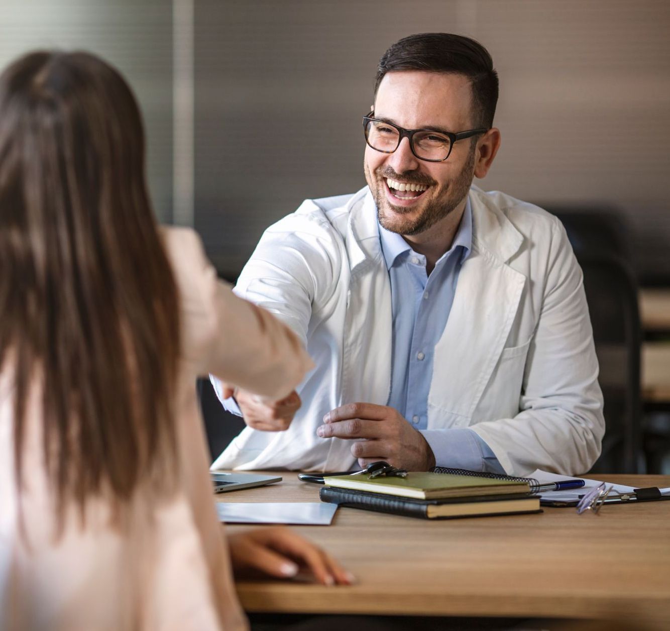 Doctor shaking hands with patient

