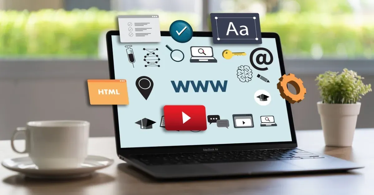 Laptop with web design icons overlaid, coffee cup, and plant on desk.