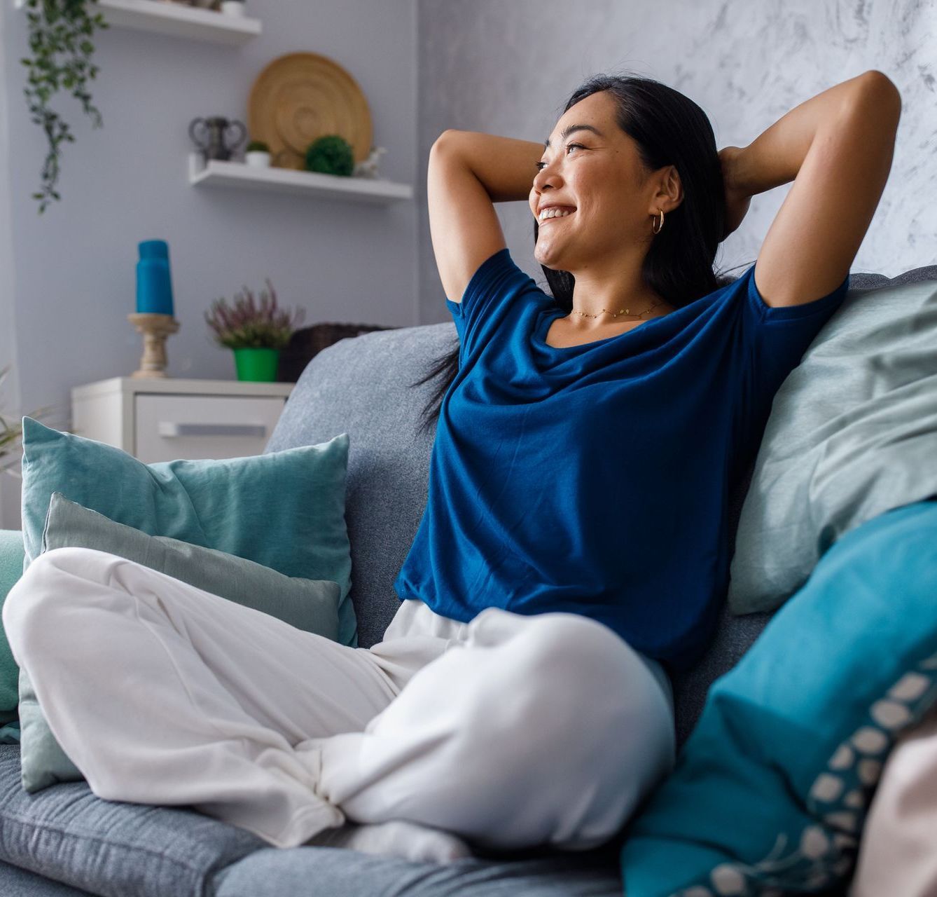 Woman smiling and sitting on couch