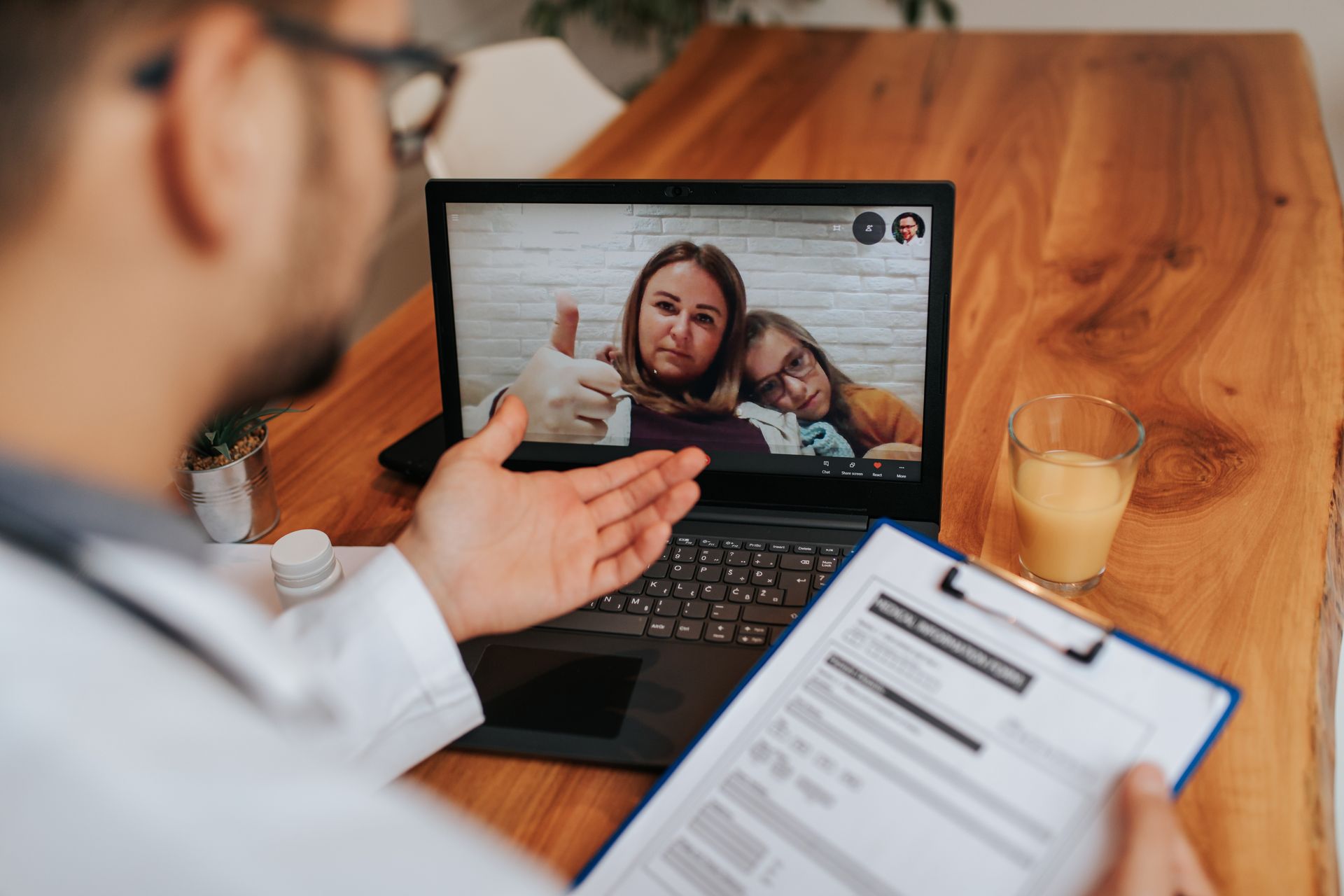 Doctor on a video conference with parent and child