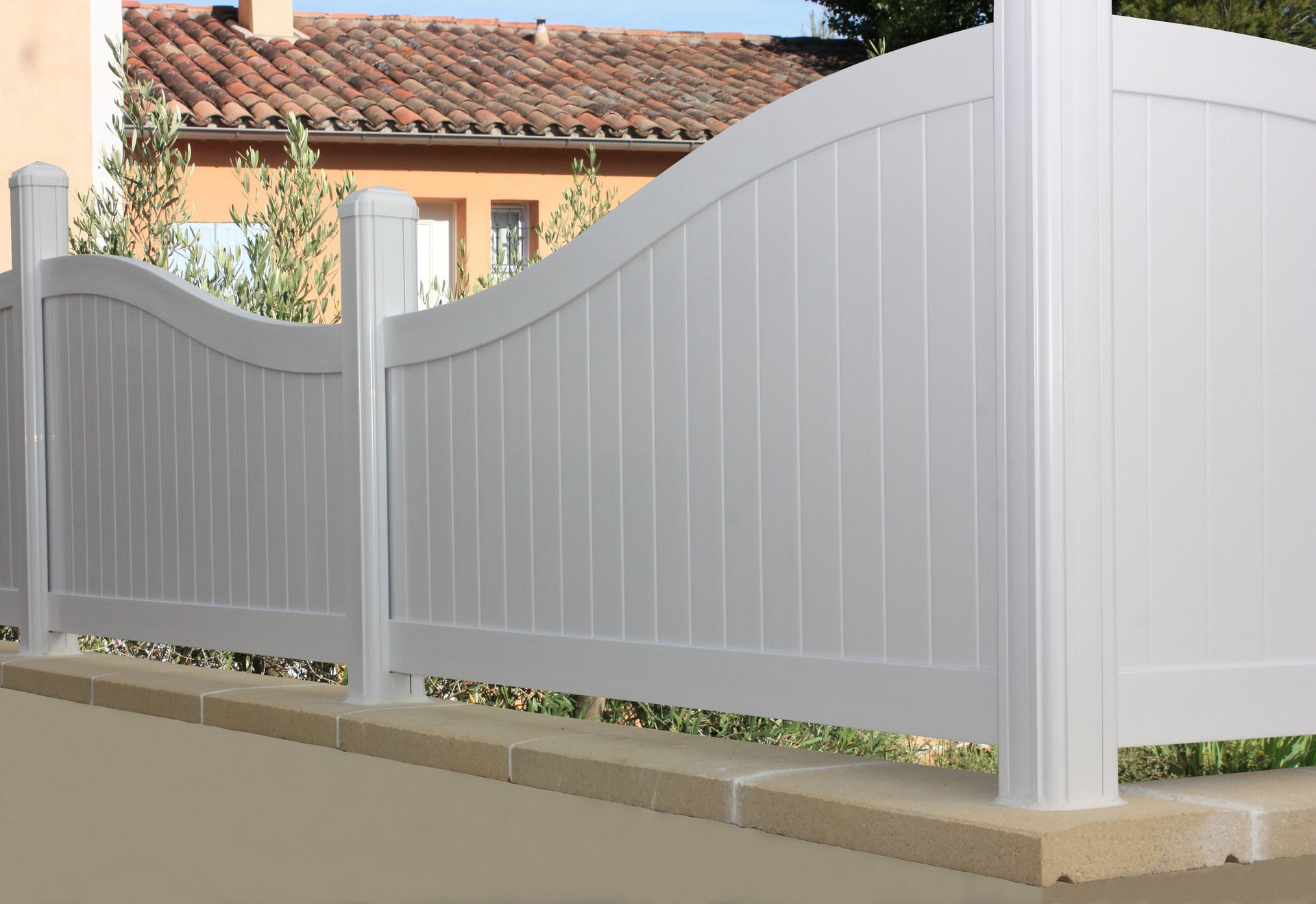 A white fence with a house in the background