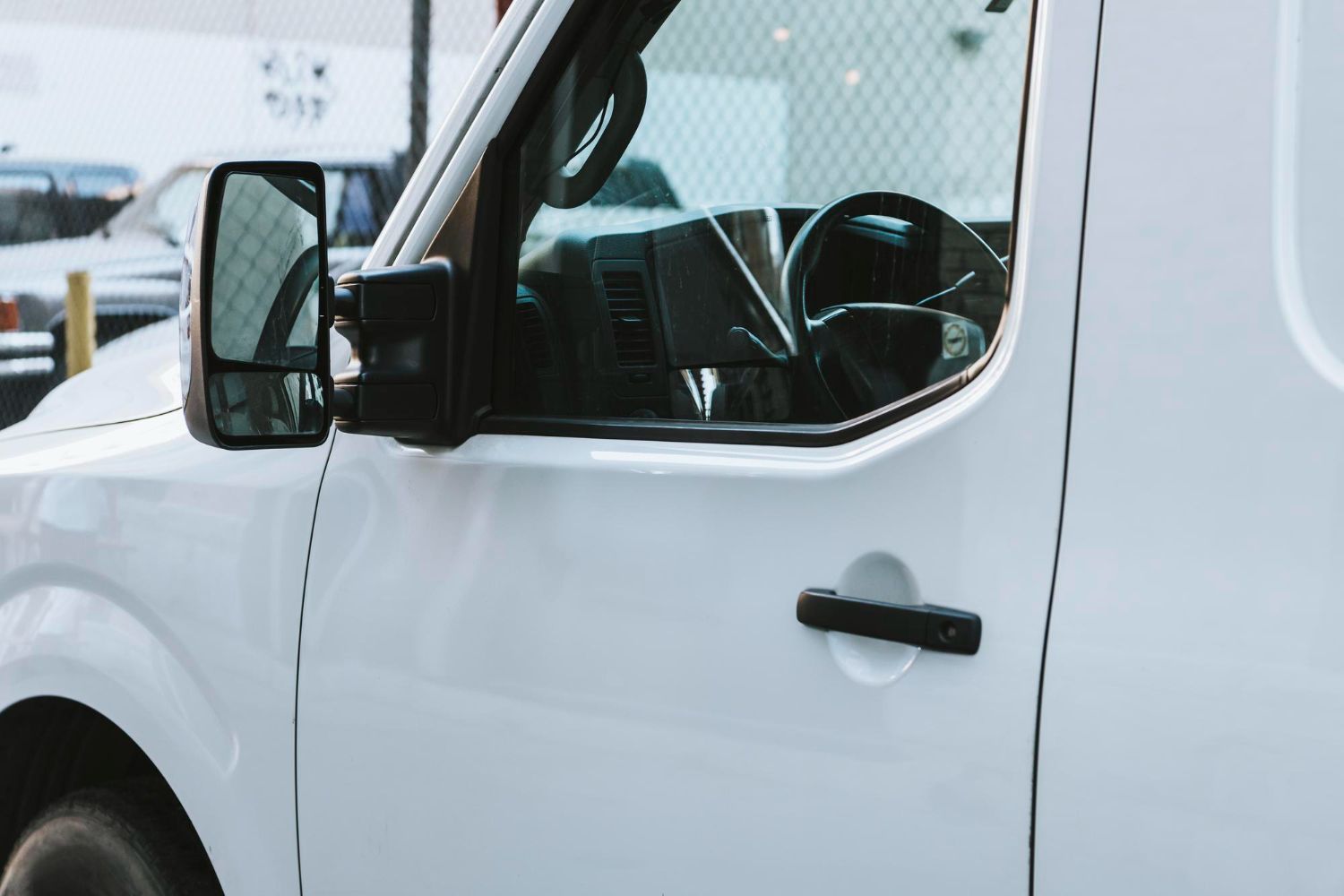A white van is parked in a parking lot.