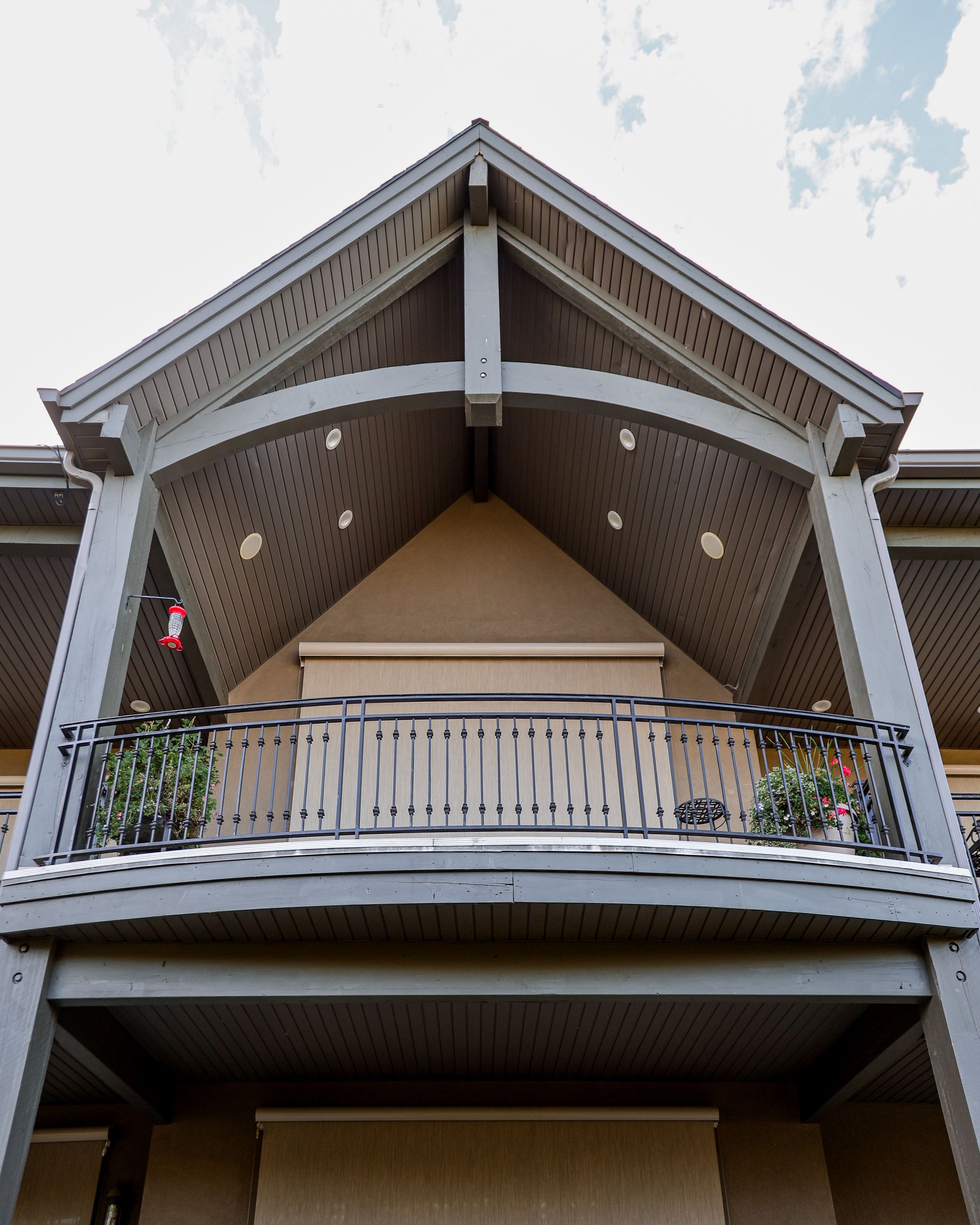 The front of a house with a balcony and a roof