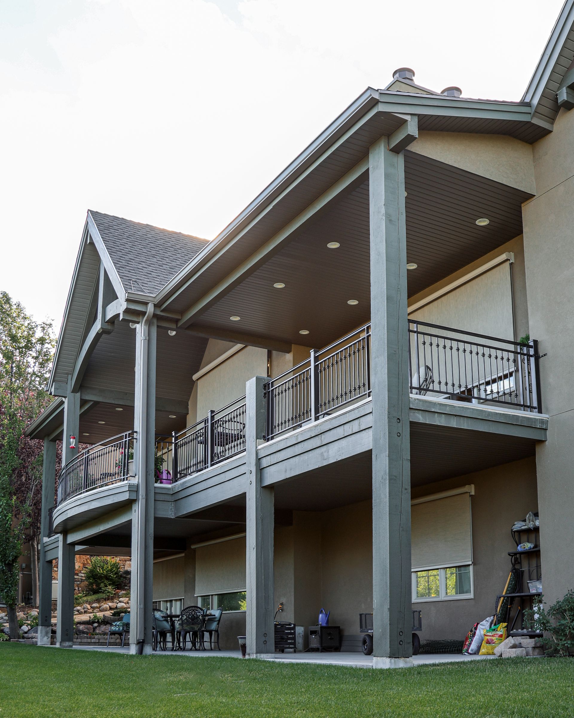 A large house with a balcony and a lawn in front of it.