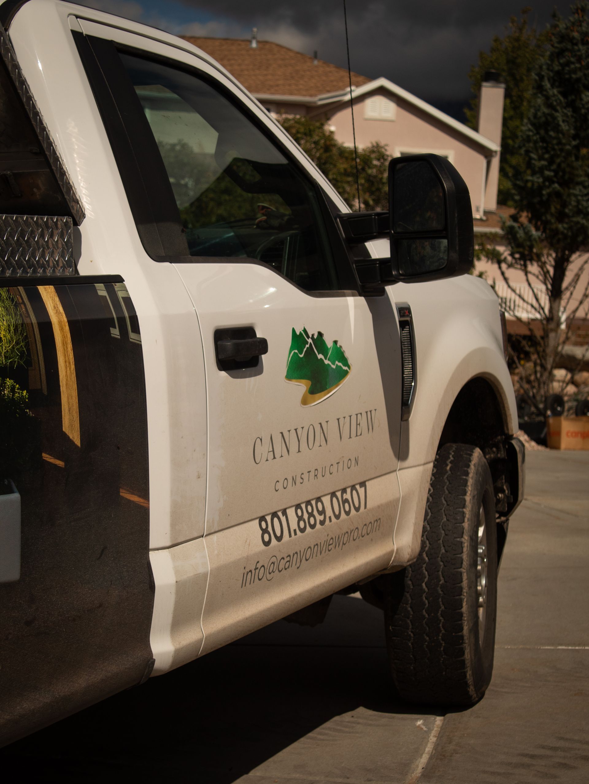 A white truck is parked on the side of the road