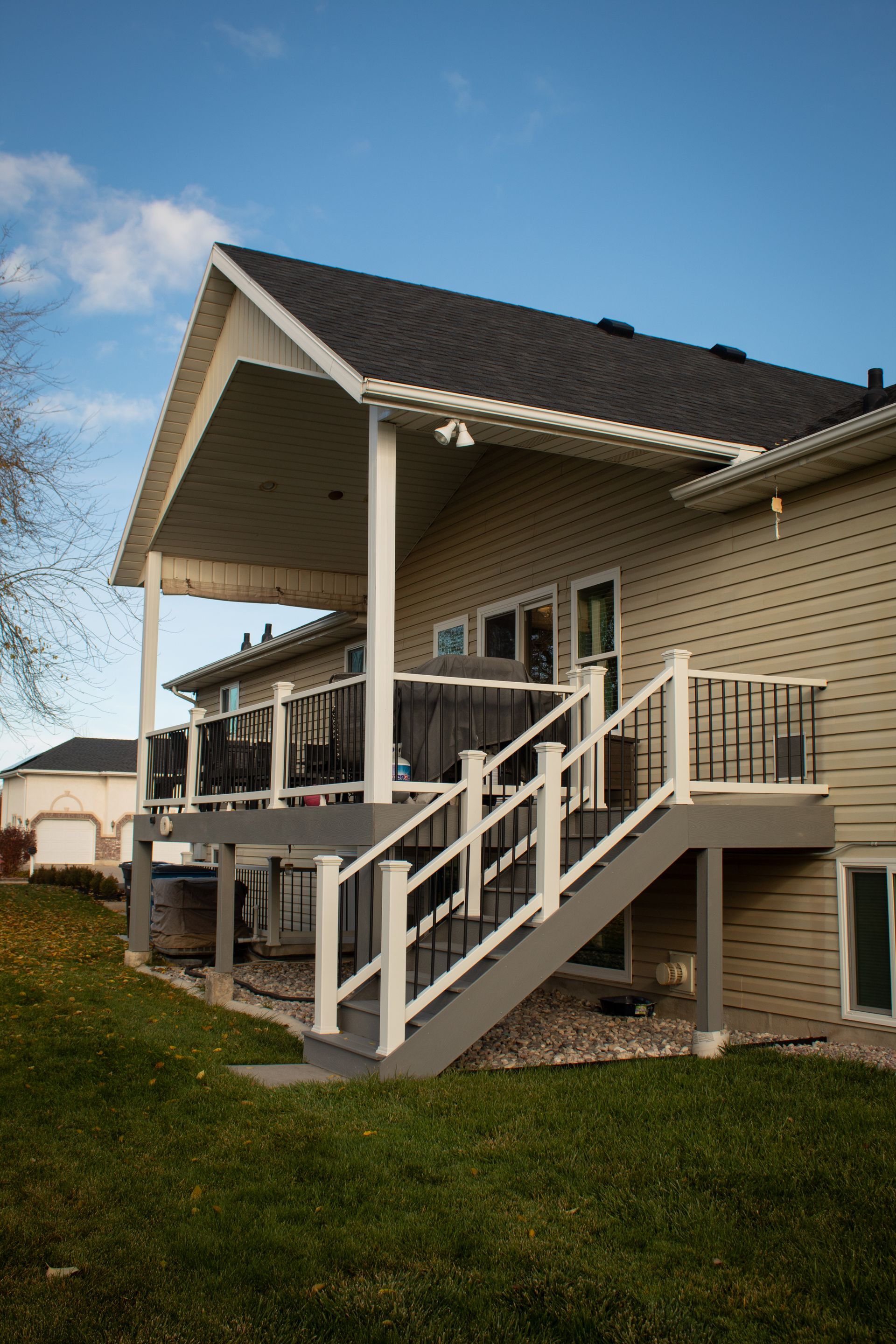 A house with a large deck and stairs leading up to it.