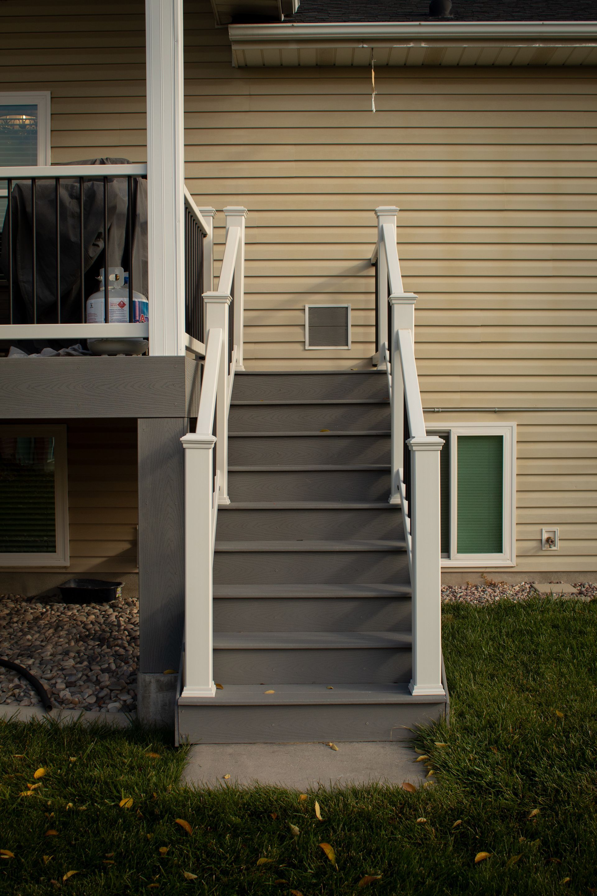 A set of stairs leading up to a porch of a house.