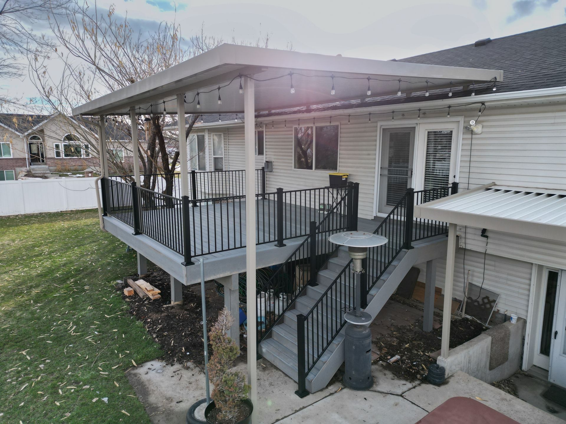 An aerial view of a deck with stairs and a canopy over it.